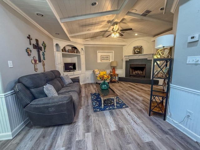 living room featuring a fireplace, wood-type flooring, vaulted ceiling with beams, ceiling fan, and wooden ceiling