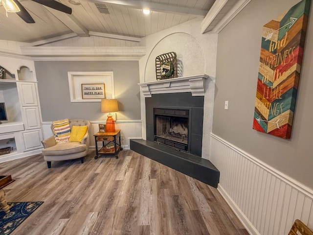 sitting room with hardwood / wood-style floors, vaulted ceiling with beams, wooden ceiling, and ceiling fan