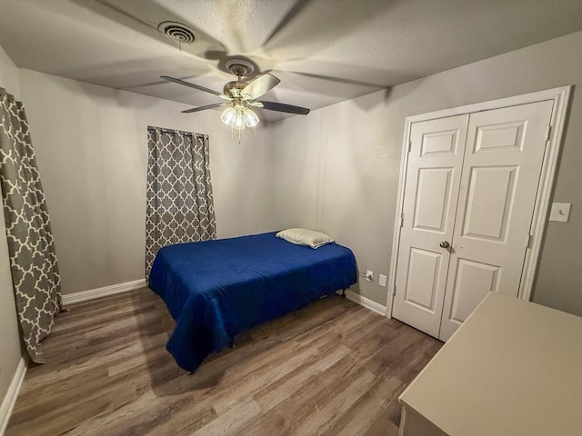 bedroom with hardwood / wood-style flooring and ceiling fan