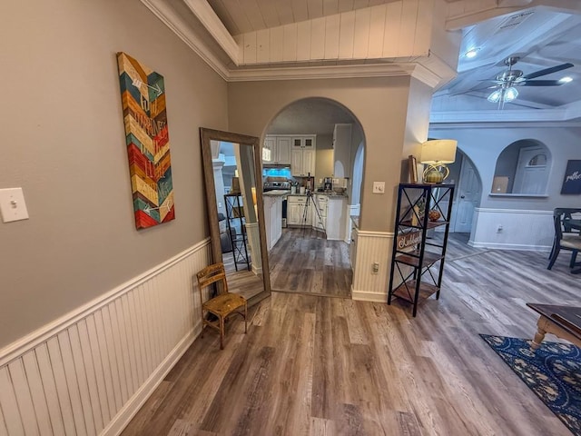 hallway featuring ornamental molding and hardwood / wood-style floors