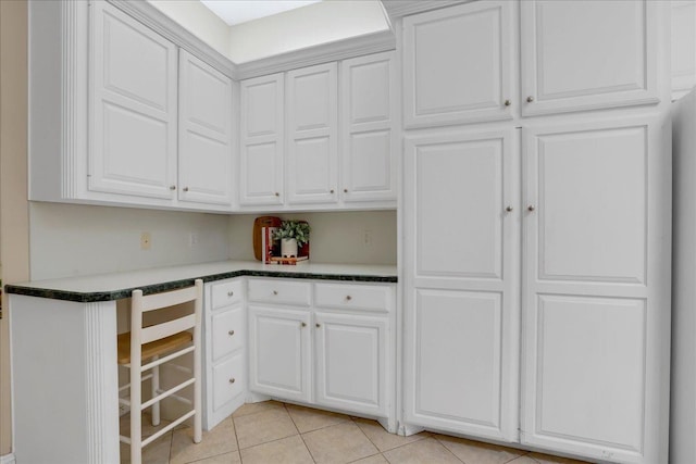 kitchen featuring white cabinetry and light tile patterned floors