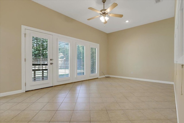 spare room featuring light tile patterned floors, french doors, and ceiling fan