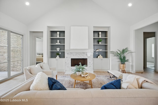 4614 138th Pl, Lubbock, TX 79424 - living room featuring high vaulted ceiling, built in features, light wood-style flooring, a fireplace, and recessed lighting
