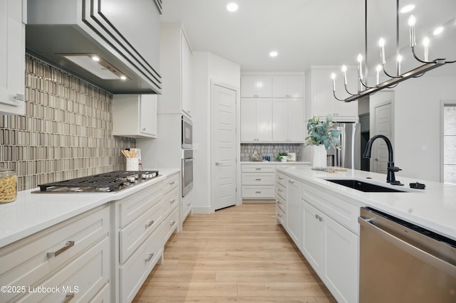 4614 138th Pl, Lubbock, TX 79424 - kitchen with appliances with stainless steel finishes, backsplash, light wood-style floors, white cabinets, and light countertops