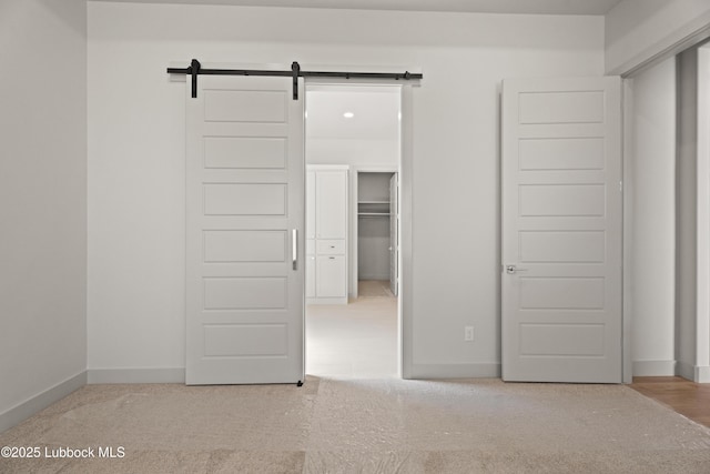 4614 138th Pl, Lubbock, TX 79424 - unfurnished bedroom featuring carpet, a barn door, and a spacious closet