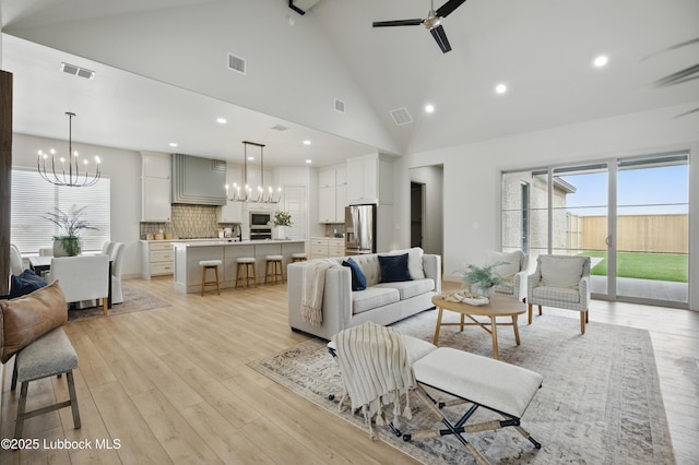 4614 138th Pl, Lubbock, TX 79424 - living room featuring ceiling fan, a chandelier, light wood finished floors, high vaulted ceiling, and recessed lighting