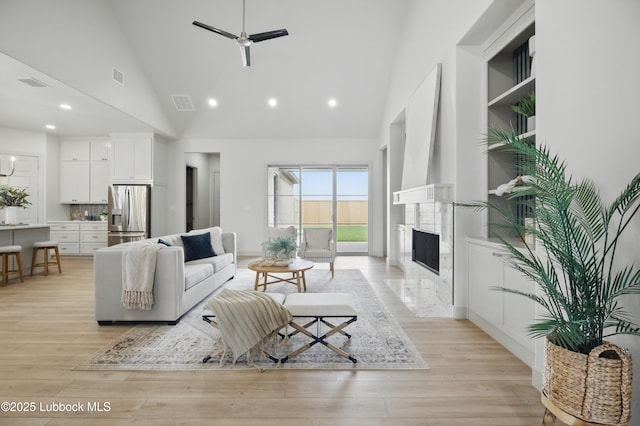 4614 138th Pl, Lubbock, TX 79424 - living area with high vaulted ceiling, ceiling fan, light wood-type flooring, recessed lighting, and a premium fireplace