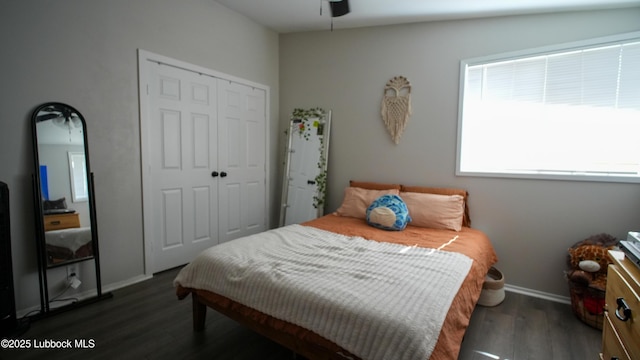 2007 68th St, Lubbock, TX 79412 - bedroom with dark wood-style flooring, a closet, baseboards, and a ceiling fan