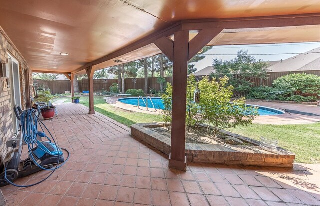 view of patio with a fenced in pool