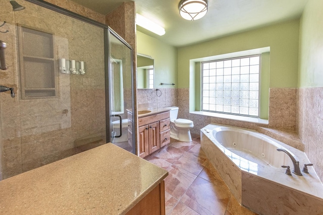 full bathroom with vanity, toilet, separate shower and tub, and tile walls