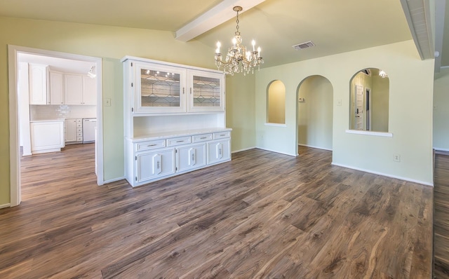 unfurnished dining area with lofted ceiling with beams, dark wood-type flooring, and a notable chandelier