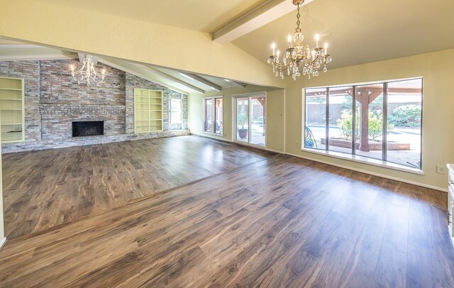 unfurnished living room with built in features, an inviting chandelier, vaulted ceiling with beams, dark hardwood / wood-style floors, and a fireplace