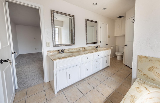 bathroom with vanity, tile patterned floors, and toilet