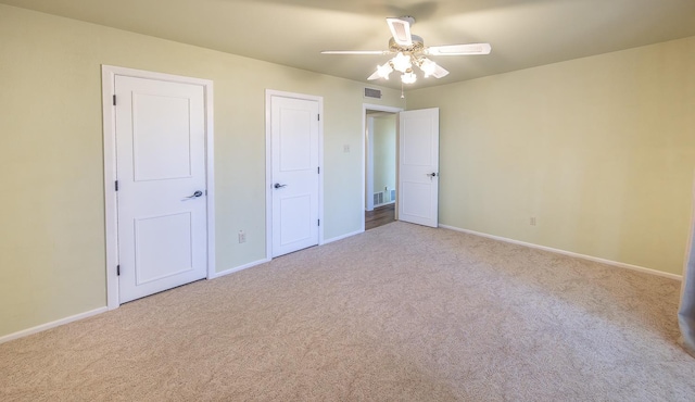 unfurnished bedroom featuring ceiling fan and light colored carpet