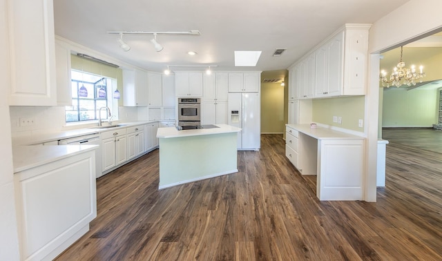 kitchen with a kitchen island, white cabinetry, sink, dark hardwood / wood-style flooring, and white refrigerator with ice dispenser