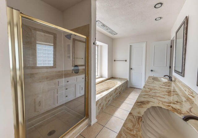 bathroom featuring vanity, plus walk in shower, tile patterned flooring, and a textured ceiling