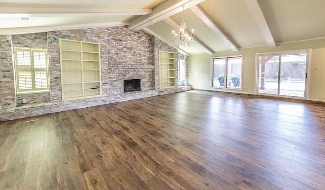 unfurnished living room featuring vaulted ceiling with beams, hardwood / wood-style flooring, a notable chandelier, a brick fireplace, and built in shelves