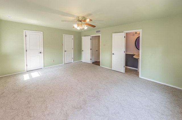 unfurnished bedroom featuring light carpet and ceiling fan