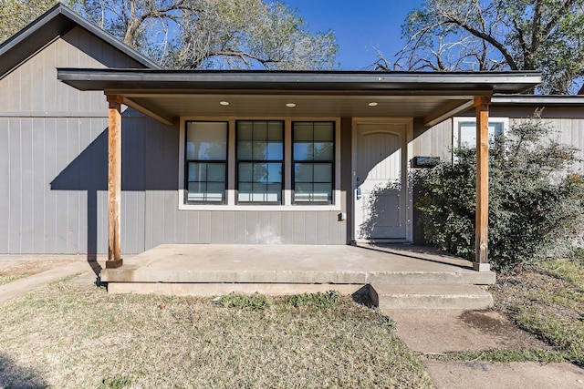 view of exterior entry with covered porch