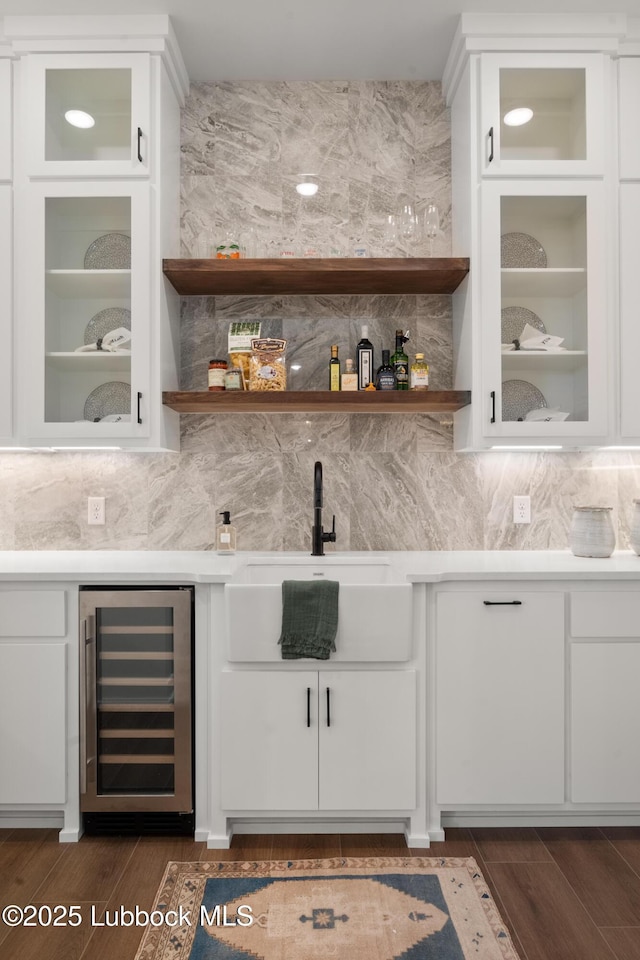 4606 138th Pl, Lubbock, TX 79424 - indoor wet bar with beverage cooler, dark wood-style flooring, and decorative backsplash