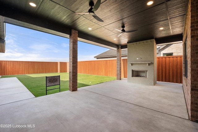 4606 138th Pl, Lubbock, TX 79424 - fenced backyard featuring a fireplace, a patio area, and ceiling fan