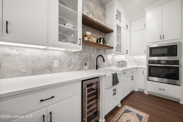 4606 138th Pl, Lubbock, TX 79424 - indoor wet bar with beverage cooler, stainless steel oven, built in microwave, dark wood-type flooring, and tasteful backsplash