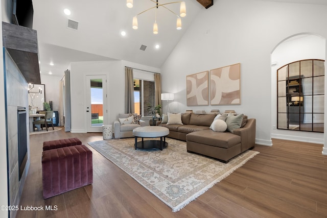 4606 138th Pl, Lubbock, TX 79424 - living room featuring high vaulted ceiling, wood finished floors, arched walkways, recessed lighting, and beamed ceiling