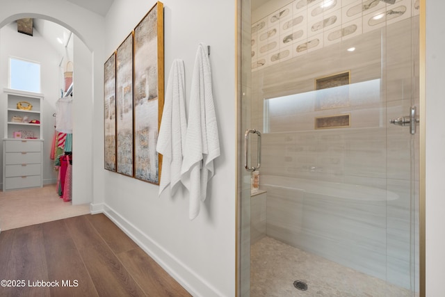 4606 138th Pl, Lubbock, TX 79424 - bathroom with a stall shower, wood finished floors, and a walk in closet