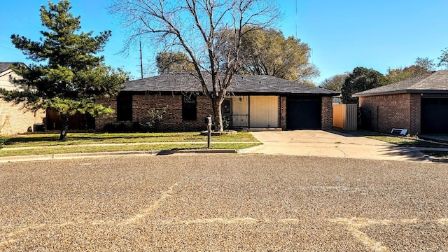 ranch-style home with a garage and a front yard