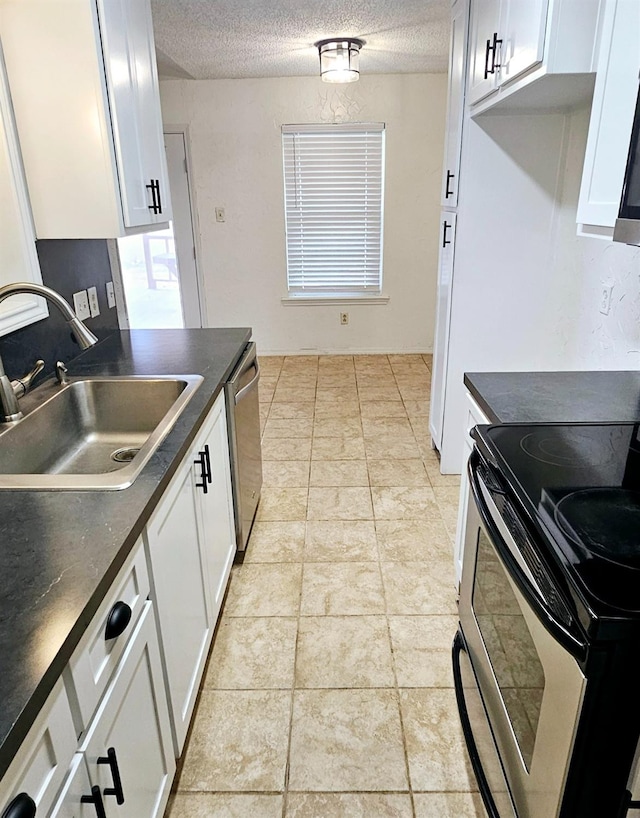 kitchen with white cabinetry, sink, a textured ceiling, and appliances with stainless steel finishes