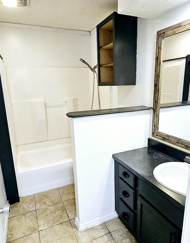 bathroom featuring tile patterned flooring, vanity, bathing tub / shower combination, and a textured ceiling