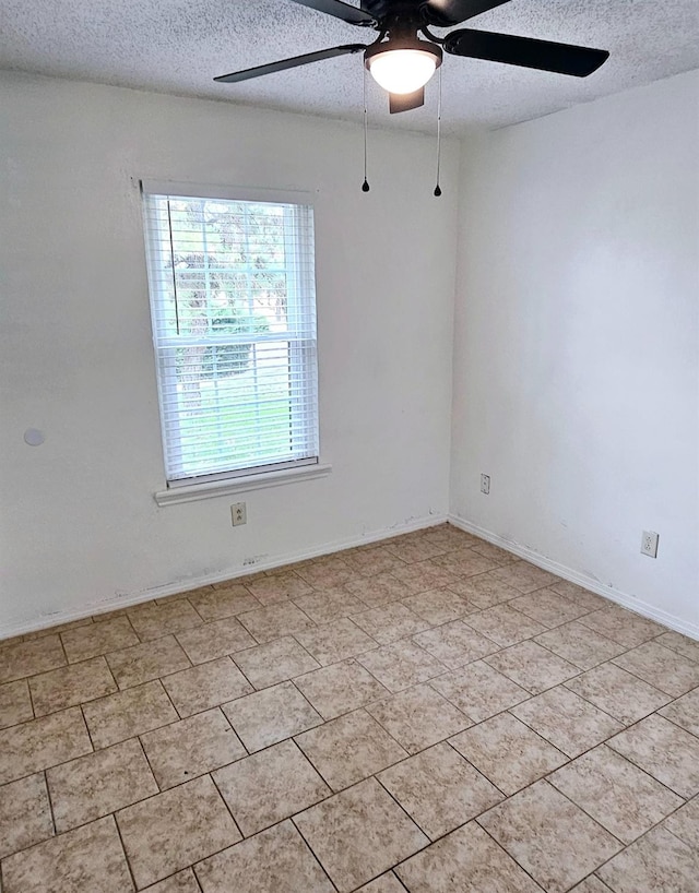 spare room with ceiling fan and a textured ceiling