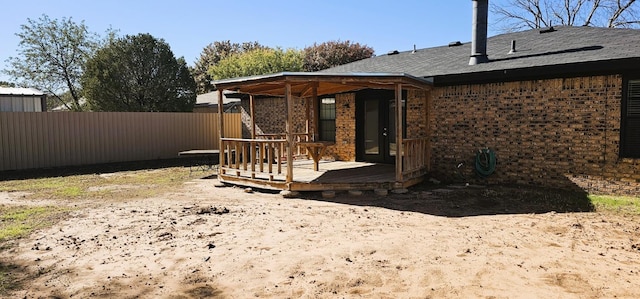 rear view of house featuring a wooden deck