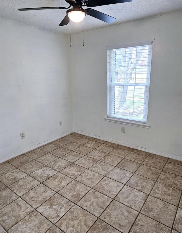 unfurnished room featuring ceiling fan and a textured ceiling