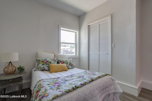 3819 30th St, Lubbock, TX 79410 - bedroom featuring wood finished floors, a closet, and baseboards