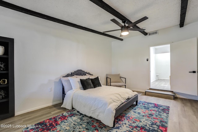 3819 30th St, Lubbock, TX 79410 - bedroom with beam ceiling, wood finished floors, a textured ceiling, ceiling fan, and baseboards