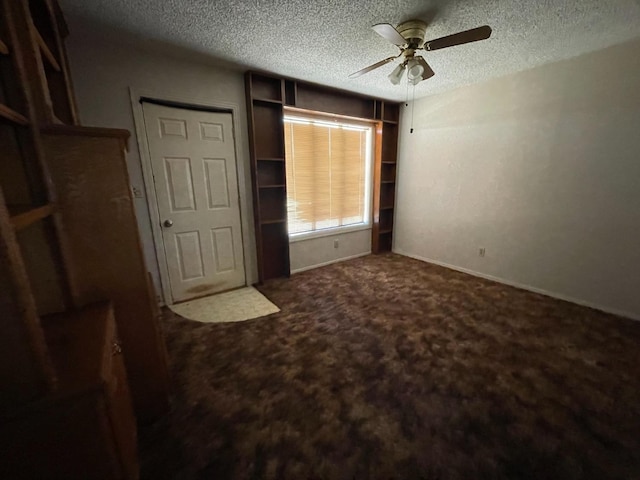 unfurnished bedroom featuring ceiling fan, carpet flooring, and a textured ceiling