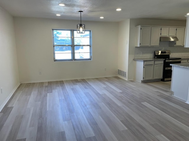 kitchen featuring stainless steel range with electric cooktop, light wood-type flooring, pendant lighting, decorative backsplash, and white cabinets