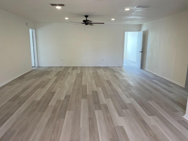 spare room featuring light hardwood / wood-style floors and ceiling fan