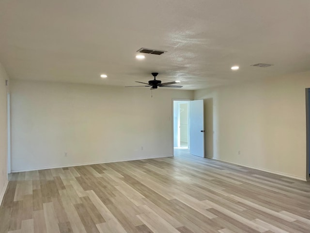 empty room with ceiling fan and light wood-type flooring