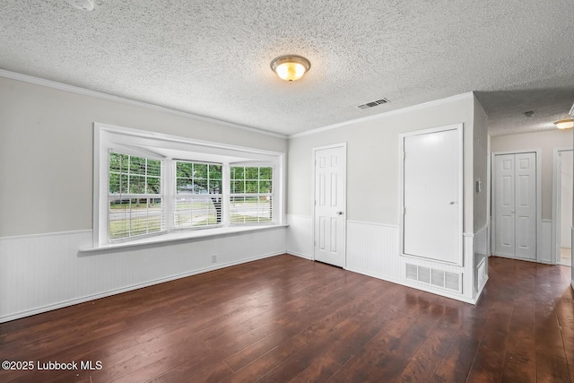 3415 39th St, Lubbock, TX 79413 - unfurnished bedroom with wood-type flooring, wainscoting, a textured ceiling, and crown molding