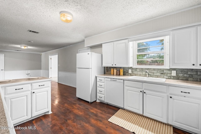 3415 39th St, Lubbock, TX 79413 - kitchen with white appliances, dark wood-style flooring, white cabinetry, a textured ceiling, and light countertops