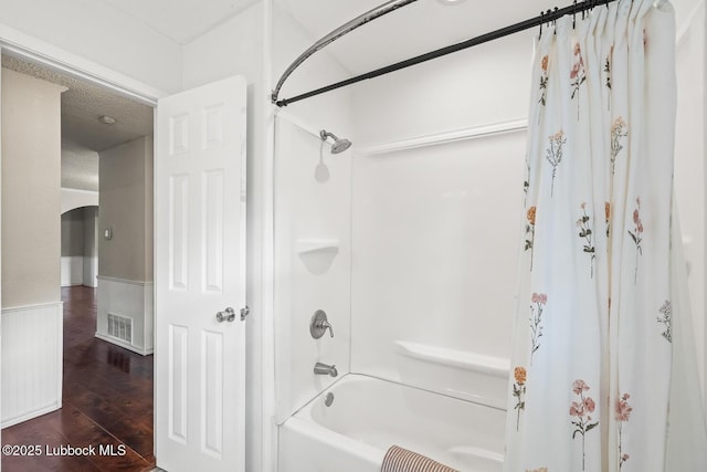 3415 39th St, Lubbock, TX 79413 - bathroom with shower / bathtub combination with curtain and wood finished floors
