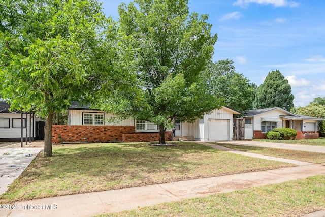 3415 39th St, Lubbock, TX 79413 - view of front of property with brick siding, driveway, a garage, and a front lawn