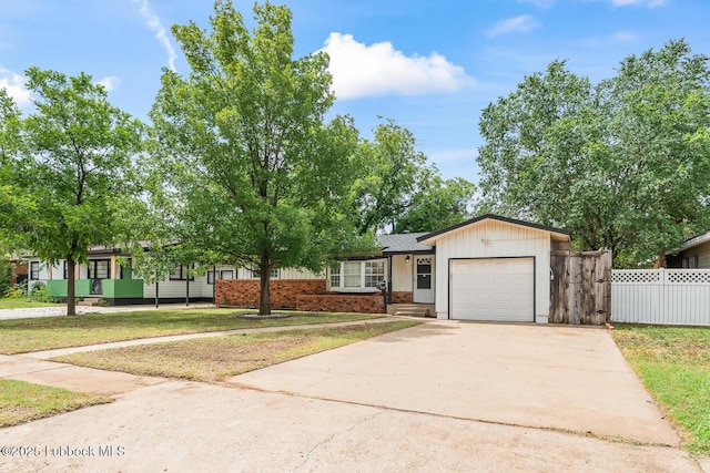 3415 39th St, Lubbock, TX 79413 - view of front of property with a garage, driveway, and brick siding