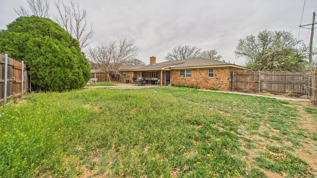 view of yard with a patio and a fenced backyard