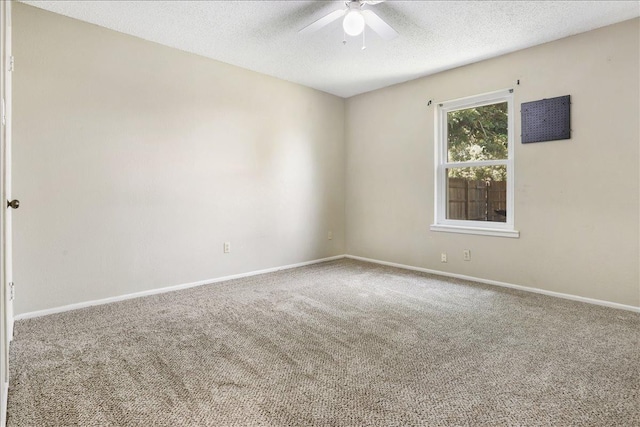 unfurnished room with ceiling fan, carpet, and a textured ceiling