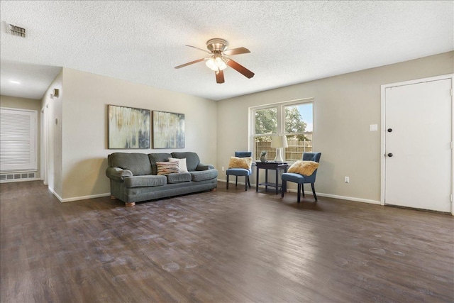 living room with dark wood-type flooring and a textured ceiling