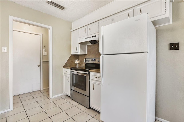 kitchen with light tile patterned floors, electric range, white cabinets, and white fridge