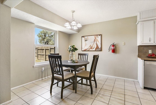 dining area featuring light tile patterned flooring, a textured ceiling, and a notable chandelier